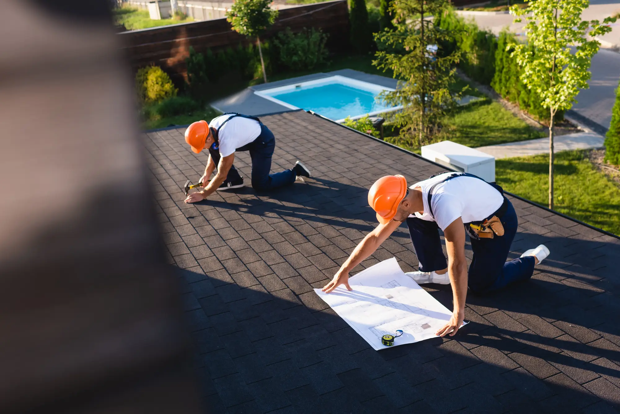 Roofing professionals reviewing replacement plans and project details