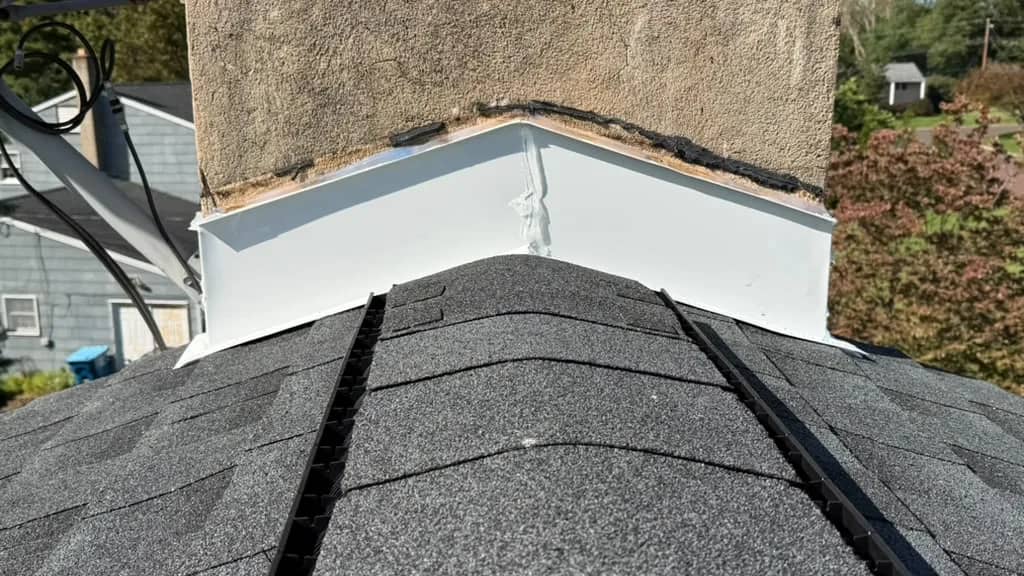 Finished ridge shingles and flashing at another Chalfont chimney base