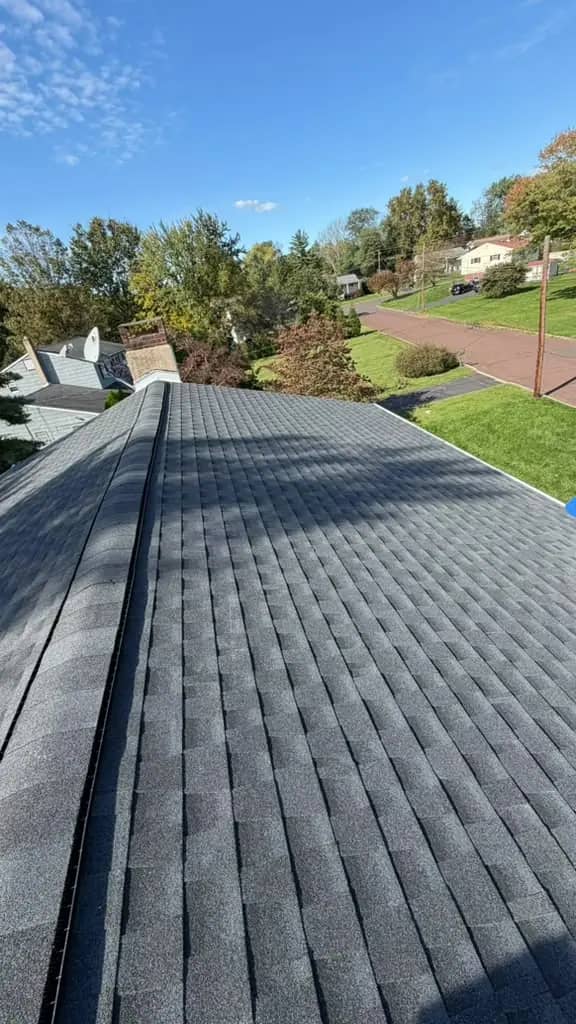 New Charcoal shingles and a long finished ridge on the Chalfont roof