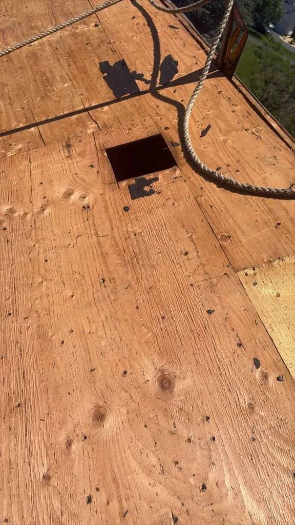 Exposed roof decking during a Jackson Township roof replacement