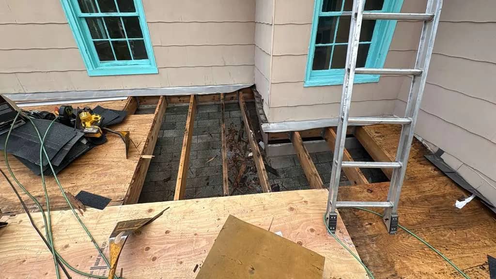 Exposed decking and open roof section during a Millville replacement