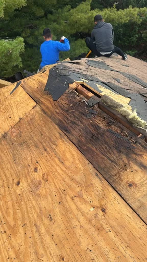 Exposed roof decking with a darkened section during Norristown tear-off