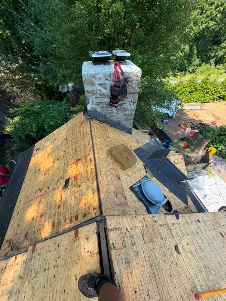 Exposed roof decking meeting a stone chimney in Penn Wynne, Pennsylvania