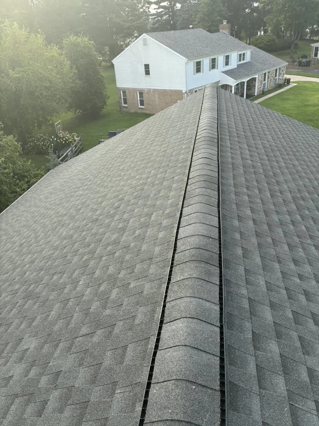 New shingles on both sides of the completed roof ridge in Southampton, Pennsylvania